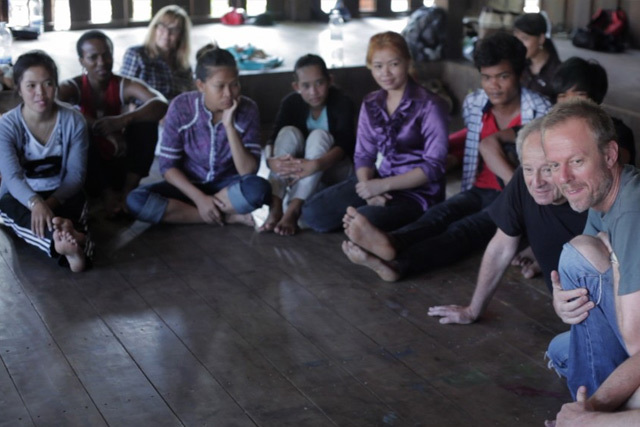 Nick Boraine and Michael Lessac and Truth in Translation cast member Andrew Buckland (far right) working with the students of the Phare circus group in Cambodia